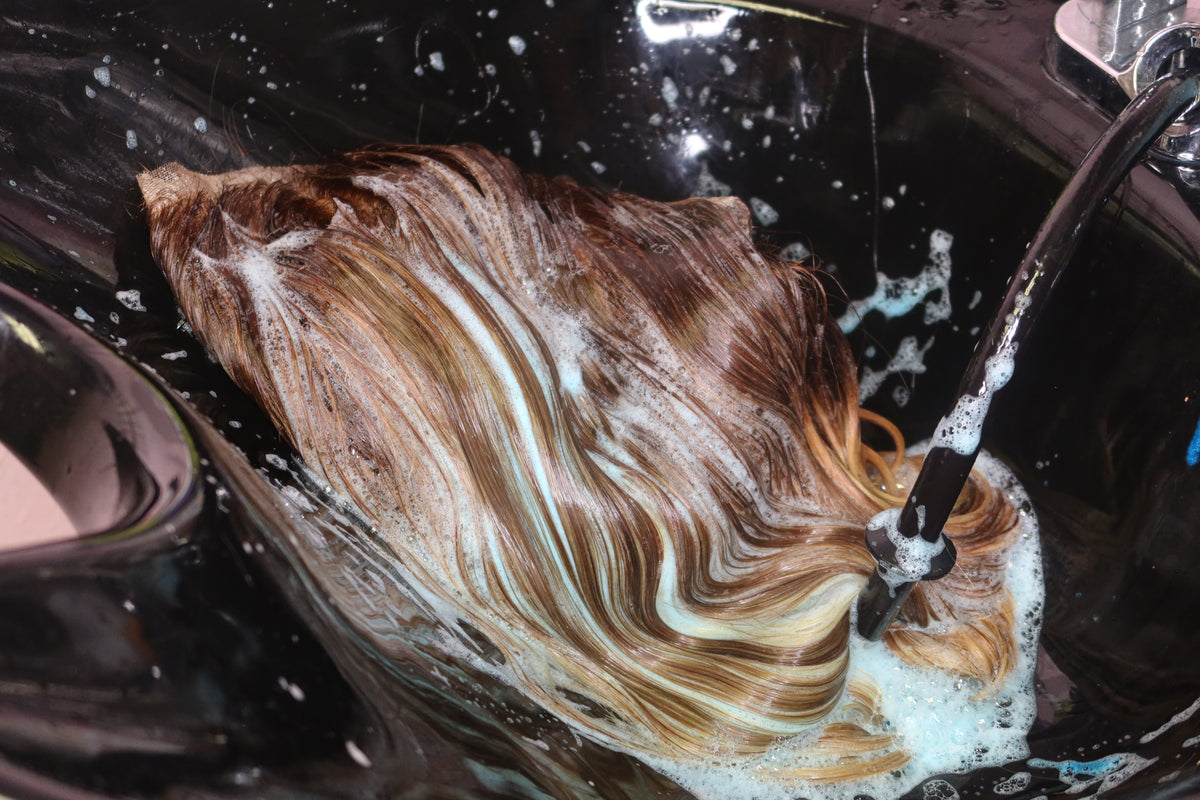 A wig being cleansed during a revamp treatment at The Wig Medics in St. Louis